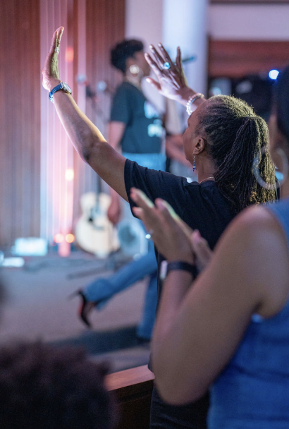 Women with hands raised in worship